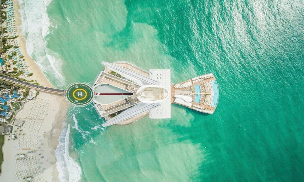 Aerial view of the Burj Al Arab, its helipad and pool terrace above the Arabian Gulf