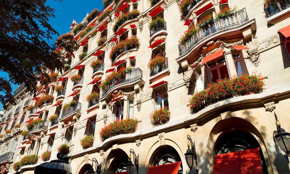 The red-awninged balconies and geraniums of Hôtel Plaza Athénée on avenue Montaigne