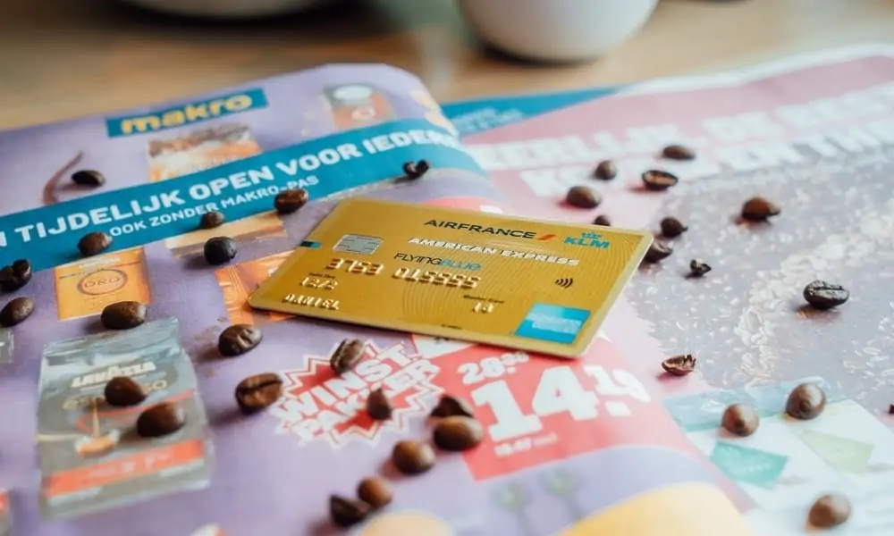 Gold Air France KLM Flying Blue American Express card on a supermarket leaflet with coffee beans