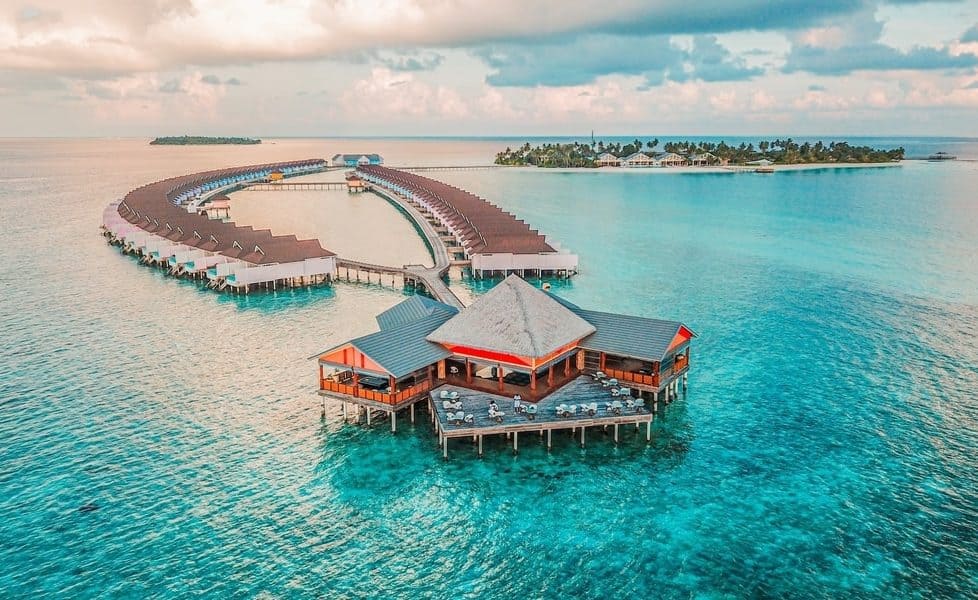 Overwater villas and a restaurant on stilts at a resort in the Maldives