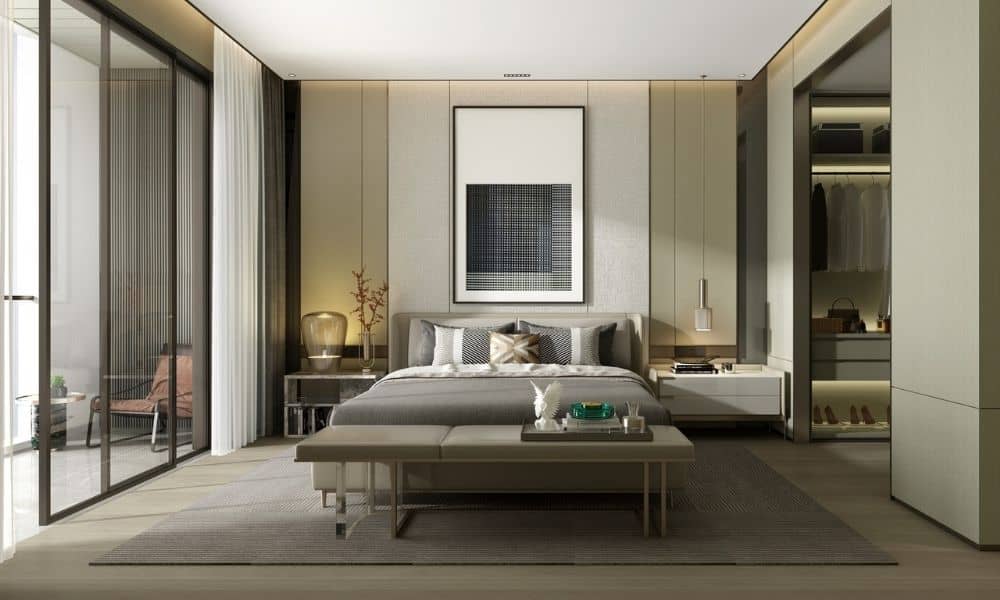 Hotel bedroom with a bench, glass doors to a balcony and a walk-in wardrobe