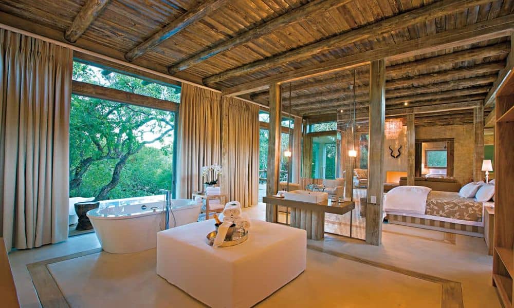 Two-bedroom Superior Family Villa interior at Kapama Karula, with freestanding bath and bedroom open to the bush