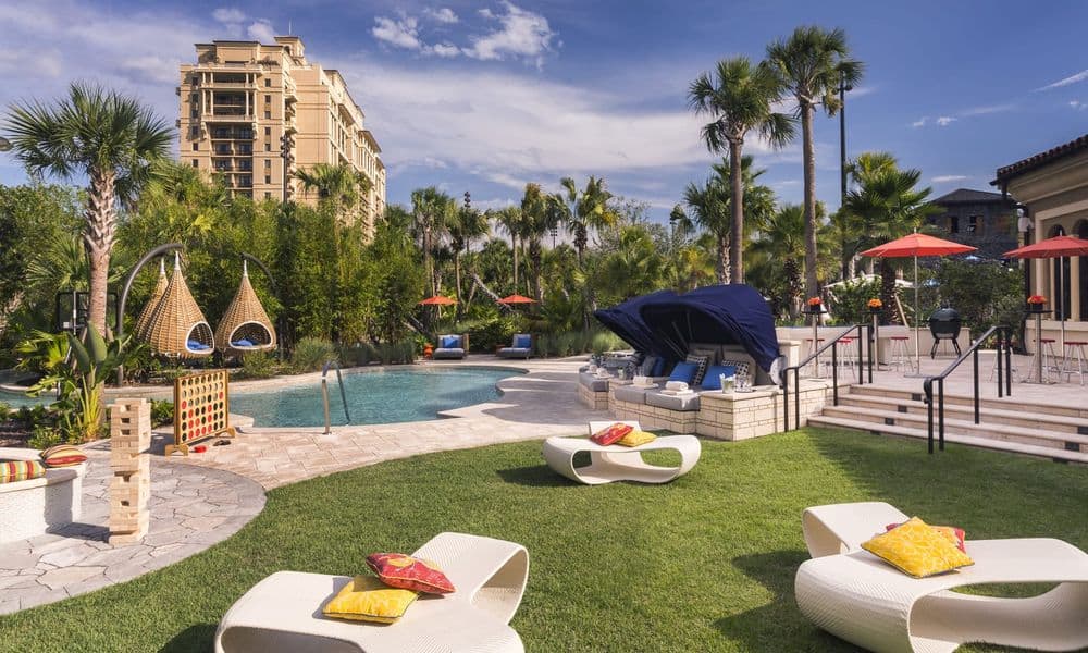 Pool and lawn games beside the Four Seasons Resort Orlando tower