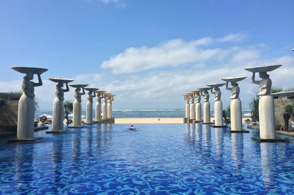 Oasis Pool at The Mulia, with Balinese statues lining the beachfront infinity pool