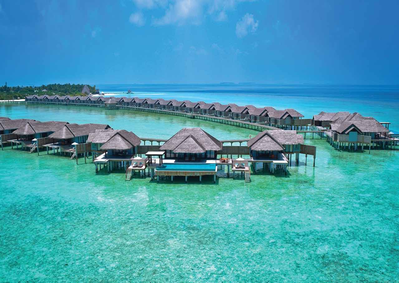 Overwater pool villas on the lagoon at Anantara Kihavah Maldives Villas