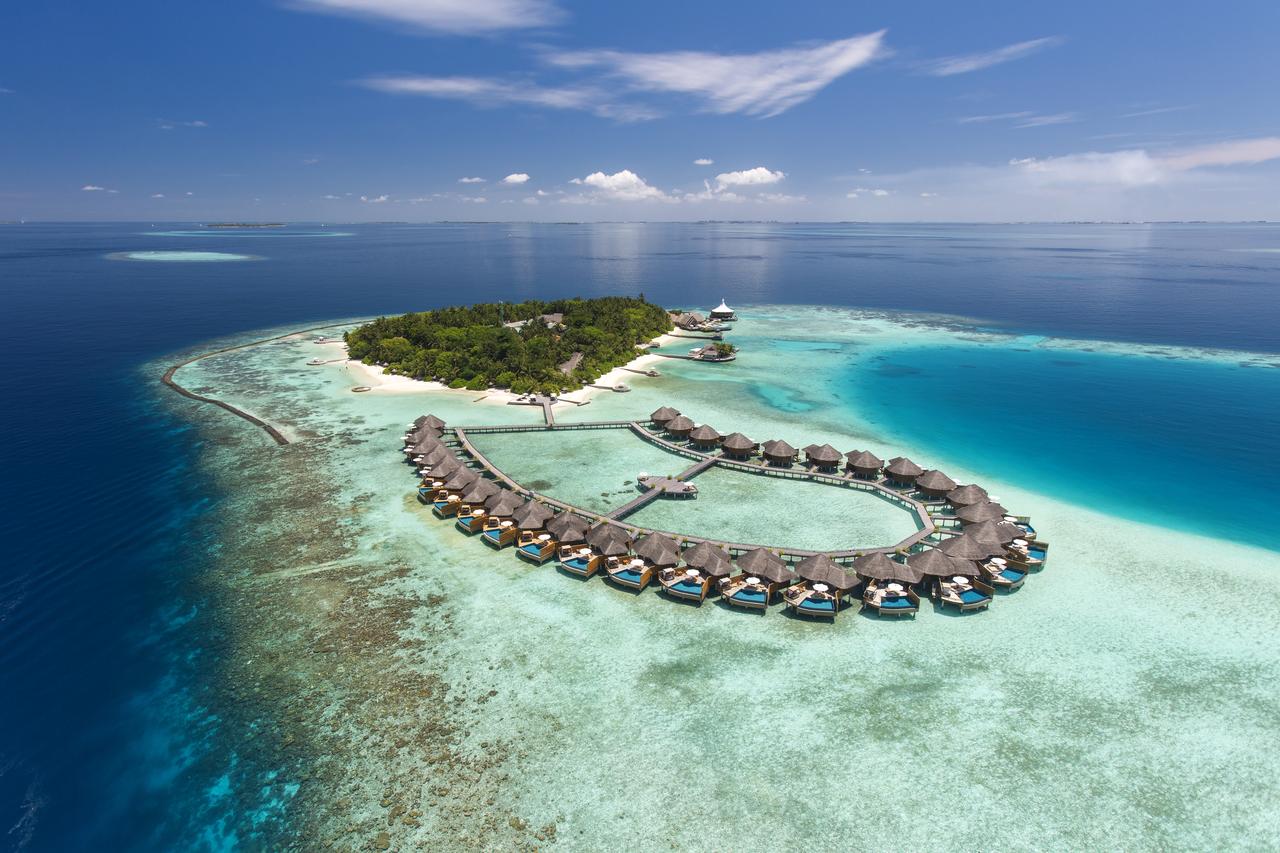 Water villas in a ring around the lagoon at Baros Maldives