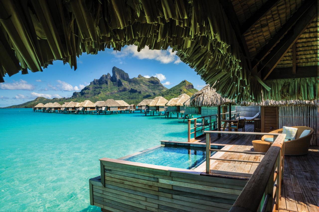 Overwater bungalow deck with plunge pool at Four Seasons Resort Bora Bora, facing Mount Otemanu