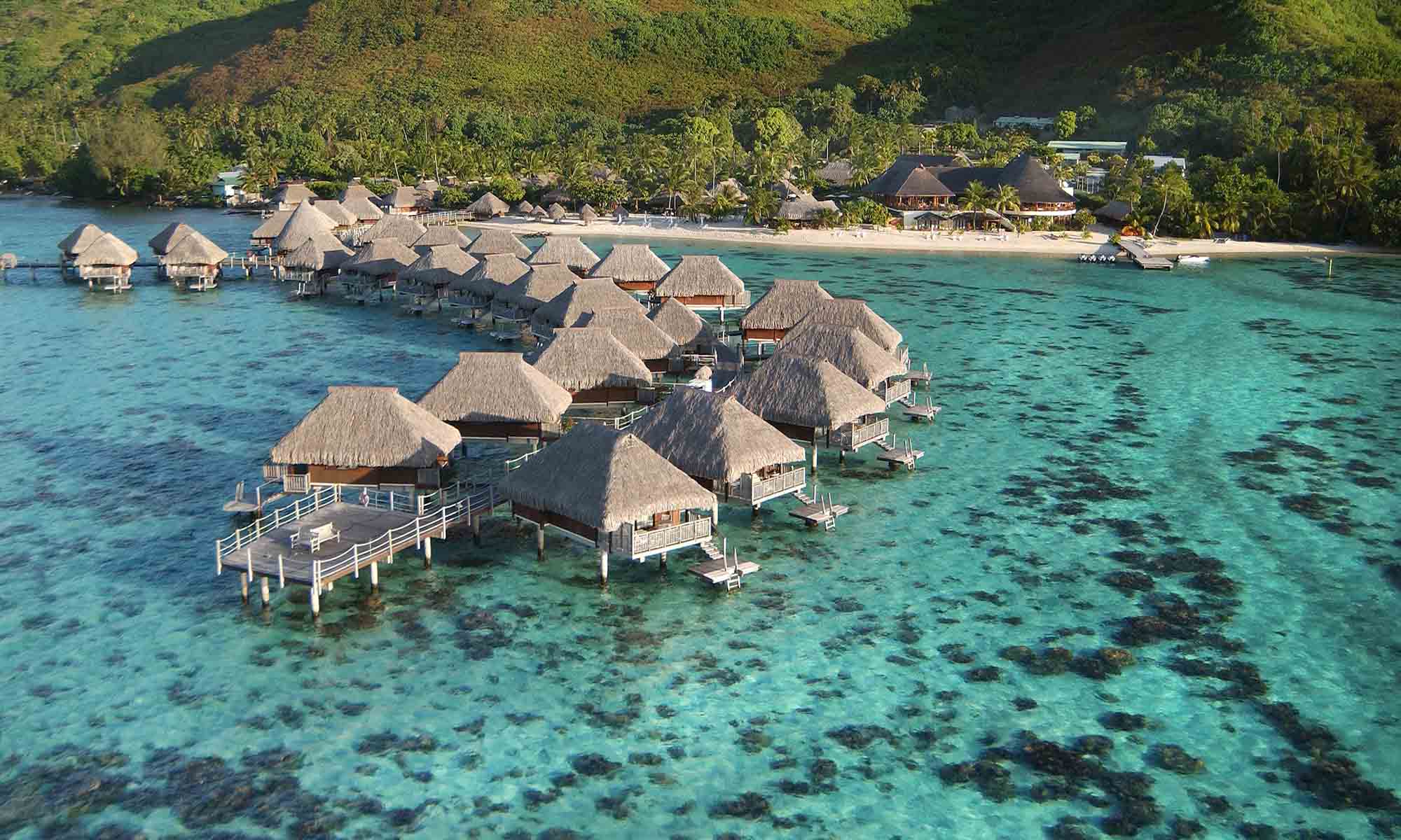 Overwater bungalows over the coral lagoon at Hilton Moorea Lagoon Resort & Spa