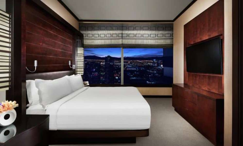 Vdara suite bedroom with a night view of the Strip