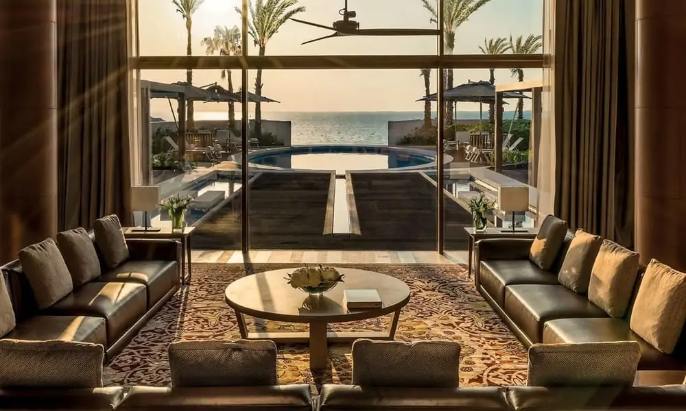 Living room of a villa at Bvlgari Resort Dubai, opening onto a pool and the sea