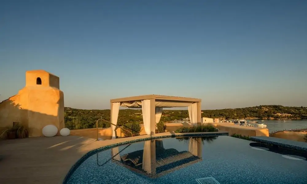 Rooftop pool and pergola of the Harrods Suite at Hotel Cala di Volpe, overlooking the bay at Porto Cervo