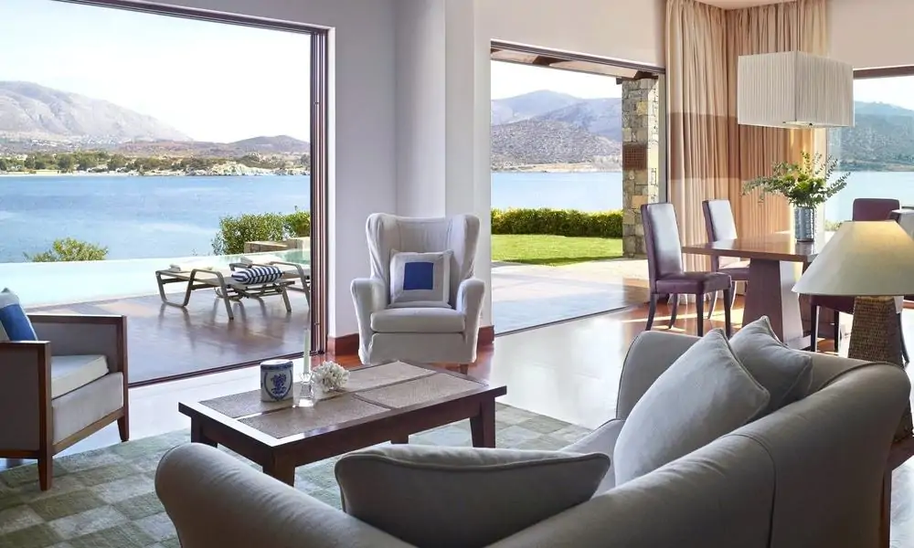 Living room of the Royal Villa at Grand Resort Lagonissi, opening onto a terrace and pool by the sea