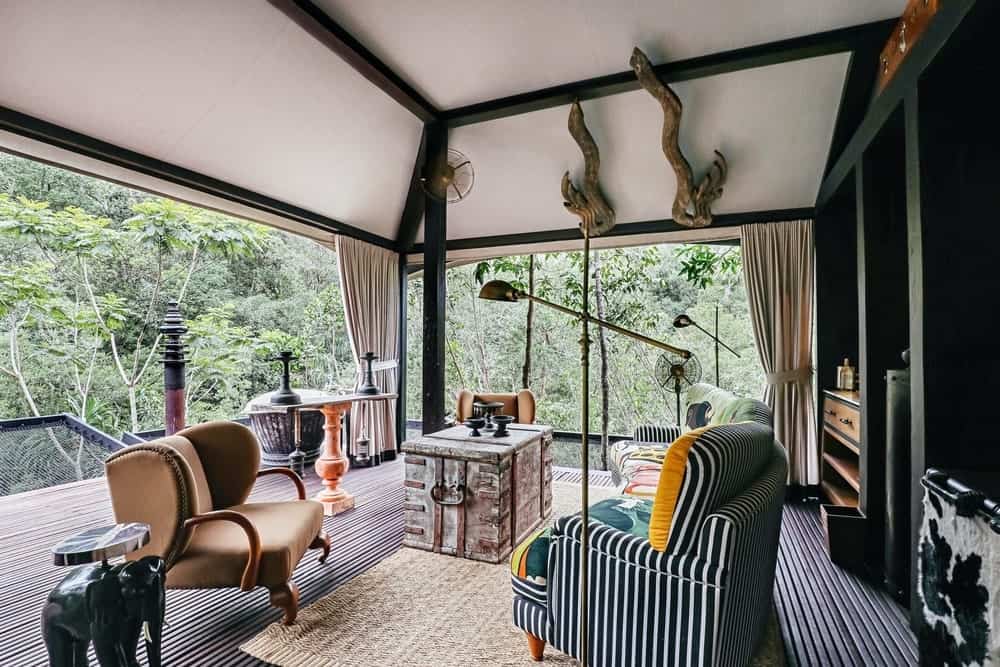 A tent interior at Shinta Mani Wild with an open deck facing the forest
