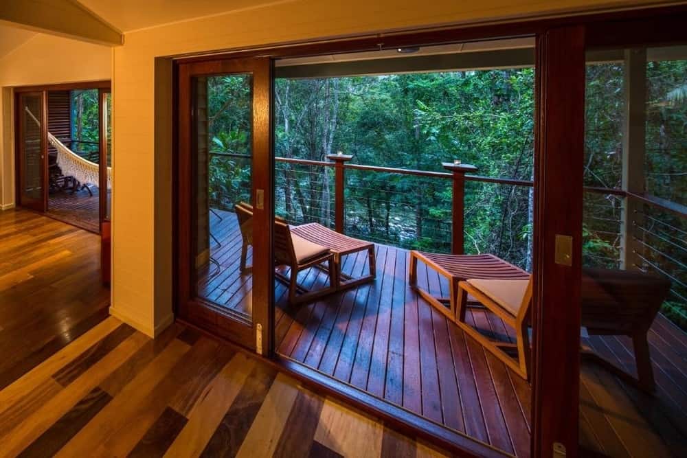 A Silky Oaks Lodge room opening onto a timber balcony in the rainforest