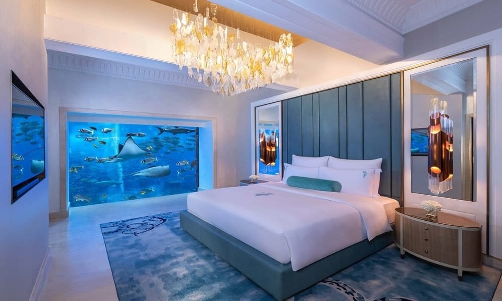 Bedroom of the Underwater Suite at Atlantis The Palm, with a window into the Ambassador Lagoon aquarium