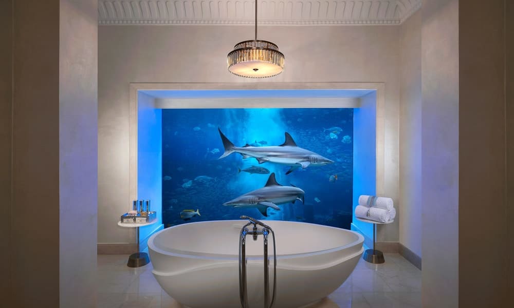 Freestanding bath facing an aquarium window with sharks at Atlantis The Palm, Dubai