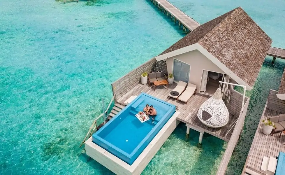 Overwater villa with a private plunge pool above a lagoon in the Maldives